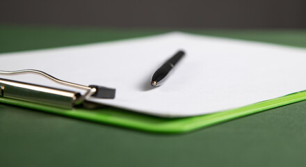 Pen and contract on the green background.