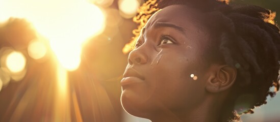 Touched by His Grace. Beautiful young woman looking up with tears in her eyes. Christian concept
