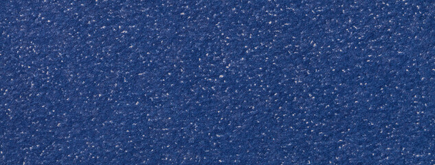 Texture of craft navy blue colors paper background with white spots, macro. Vintage dark denim...