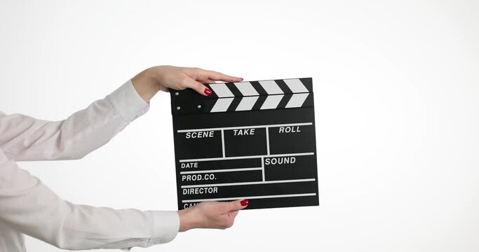 Woman hands hold clapperboard movie during short film production on white background. Focus on movie clapperboard