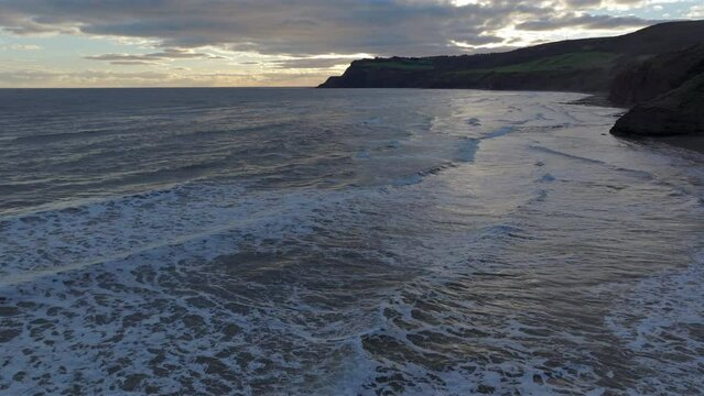 Establishing Drone Shot of North Yorkshire Cliffs Coastline at Sunrise