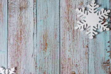 White snowflakes on a light blue background. Winter New Years Christmas flatlay with copyspace