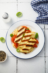 Grilled halloumi cheese with couscous and vegetables