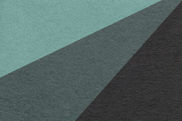 Fototapeta premium Texture of old craft cyan, teal and black color paper background, macro. Vintage abstract cardboard