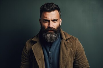 Fototapeta premium Portrait of a handsome bearded man in a brown jacket. Men's beauty, fashion.