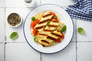 Grilled halloumi cheese with couscous and vegetables
