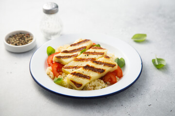 Grilled halloumi cheese with couscous and vegetables