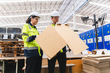 Professional worker team in safety uniform, supervisor inspector in packaging stock order at cardboard factory warehouse, piles of stacking paper manufacture, recycling industrial production - obrazy, fototapety, plakaty