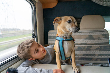Boy traveling with his dog in a motorhome