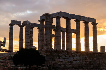 Greece Cape Sounio. Ruins of an ancient temple of Poseidon, Greek god of the sea, on sunset.Tourist...