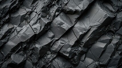 Textured black stone background created by a dark grey, rugged mountain surface with prominent cracks. Designers have plenty of space for creativity.
 - obrazy, fototapety, plakaty