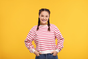 Smiling woman with braces on orange background