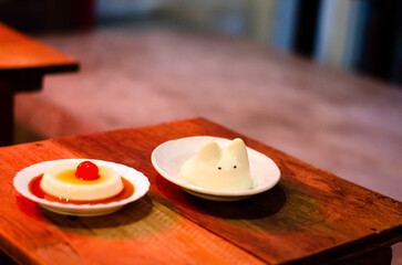 Kiwi cream pudding, Panna Cotta with kiwi sauce, on a plate. Light gray background 