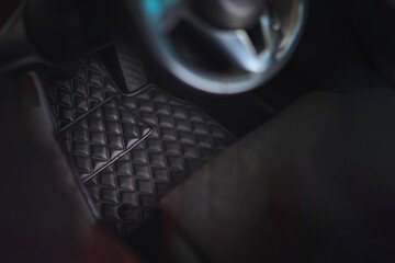 Luxury leather floor mat modern car interior driver's side. Auto service industry. Interior of a...