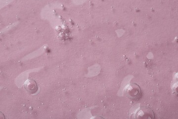 Cosmetic serum on pink background, top view