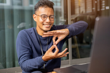 close up asian indian man make gesture hand about sign language to teaching or talking to colleague...