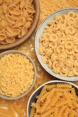 Different types of pasta on table, flat lay