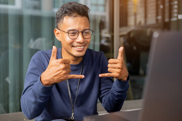 close up asian indian man make gesture hand about playing sign language to teaching or talking to colleague in office meeting room for business lifestyle concept
