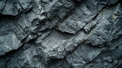 Dark grey, cracked mountain surface forming a textured black stone background. A spacious canvas for design purposes.
