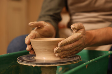 Clay crafting. Man making bowl on potter's wheel, closeup