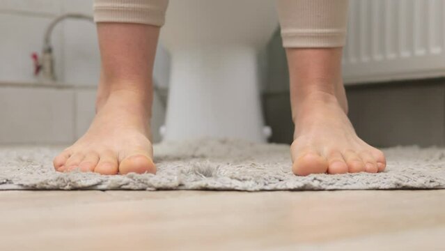 Unrecognizable woman sitting on toilet bowl in bathroom has stomach ache poor digestive system constipation diarrhea food poisoning
