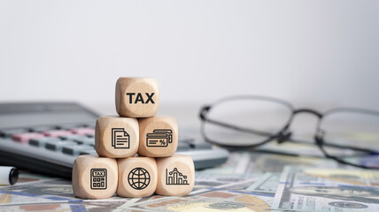 Tax concept with icons on wooden blocks Tax reduction planning, expenses, accounting, VAT and...