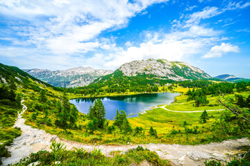 Großsee on the high plateau of the Tauplitzalm. View of the lake at the Totes Gebirge in Styria. Idyllic landscape with mountains and a lake on the Tauplitz.