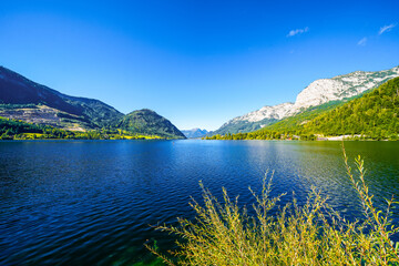 Fototapeta na wymiar View of the Grundlsee and the surrounding landscape. Idyllic nature by the lake in Styria in Austria. Mountain lake at the Totes Gebirge in the Salzkammergut. 
