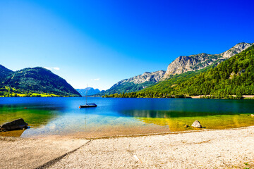 View of the Grundlsee and the surrounding landscape. Idyllic nature by the lake in Styria in Austria. Mountain lake at the Totes Gebirge in the Salzkammergut.
