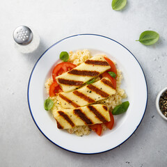 Grilled halloumi cheese with couscous and vegetables