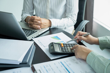 Businesswomen working together at desk.