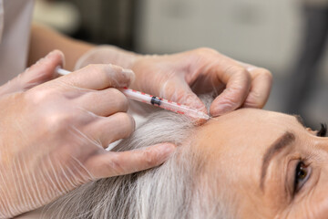 Woman having beauty procedures at beauty clinic and receiving beauty injections