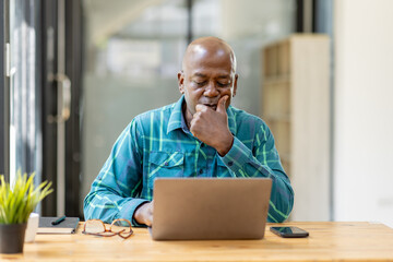 Business senior man 60 years old using laptop computer and thinking about question in office. Happy middle aged man, entrepreneur, small business owner working online. - obrazy, fototapety, plakaty