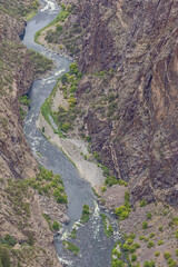 Obraz premium The Gunnison River winding through the Black Canyon at the base of the painted wall, seen from Cedar Point