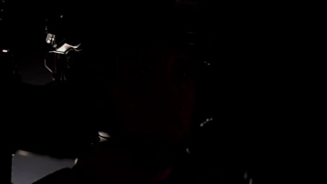 Close up face of young military soldier. Special forces warrior. Private military company. War addiction of mercenary in army camouflage uniform with helmet. Flashing blinking light