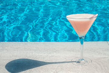 Fresh drink in glass on poolside