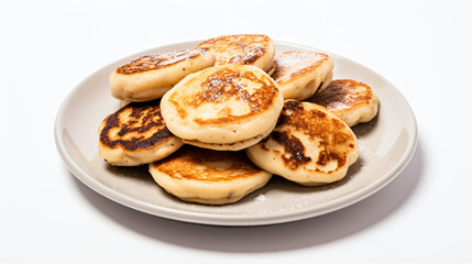 Small pancakes in a plate on a white background