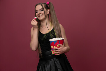 Portrait of impressed lady hand hold popcorn isolated on red color background