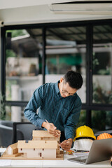 Male architect hands making model house. Man architect working in the office.