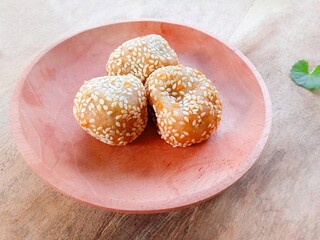 onde-onde filled with green beans. Traditional Indonesian snack, flour filled with peanuts then shaped into rounds then fried then coated with sesame seeds. fried snack for tea time or celebration
