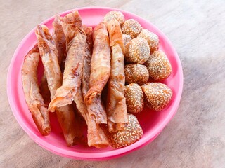 onde-onde, fried bread filled with green beans then smeared with sesame and piscok or chocolate banana wrapped in spring roll skin. traditional Indonesian snacks. fried snack for tea time