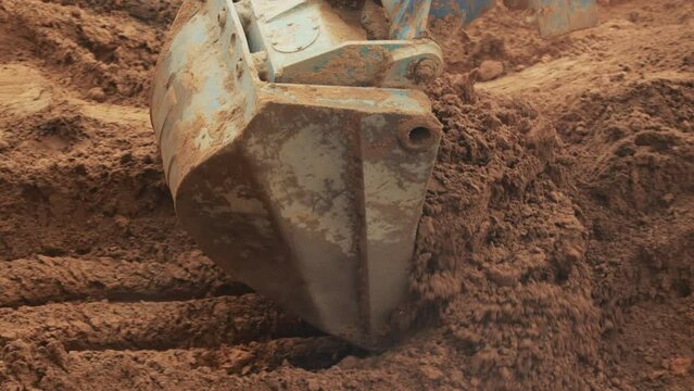 The excavator digs a hole with a telescopic rotary bucket. Pipeline replacement work, industry