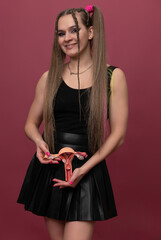woman holds model of female reproductive system in the hands. Help and care concept