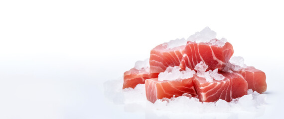 Cubes of tuna meat on a white cutting table with crushed ice. Banner concept for a fish store or seafood department. - obrazy, fototapety, plakaty