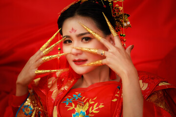 Chinese new year , Portrait of young asian woman with traditional red Chinese hong hao cheongsam in temple ,