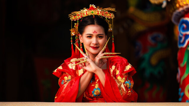 Chinese new year , Portrait of young asian woman with traditional red Chinese hong hao cheongsam in temple ,