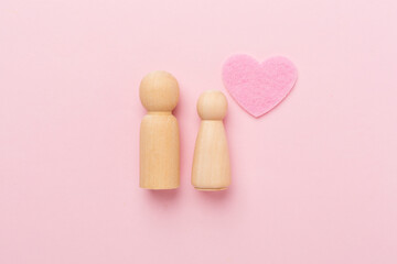 Wooden couple in love on color background, top view. Creative valentine's day composition