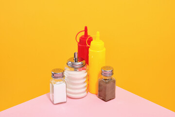 Preparing delicious food with mustard, ketchup and other spices. Table in the cafe.