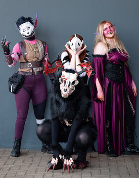 Female cosplayers at Comic-Con in monster outfits.