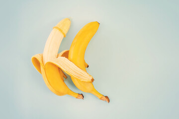 bananas, condoms on blue background. concept of protection against sexually transmitted diseases....